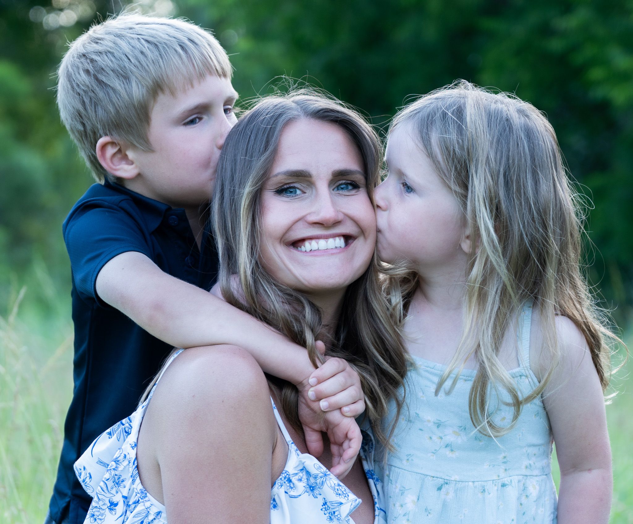 Kids kiss mom.