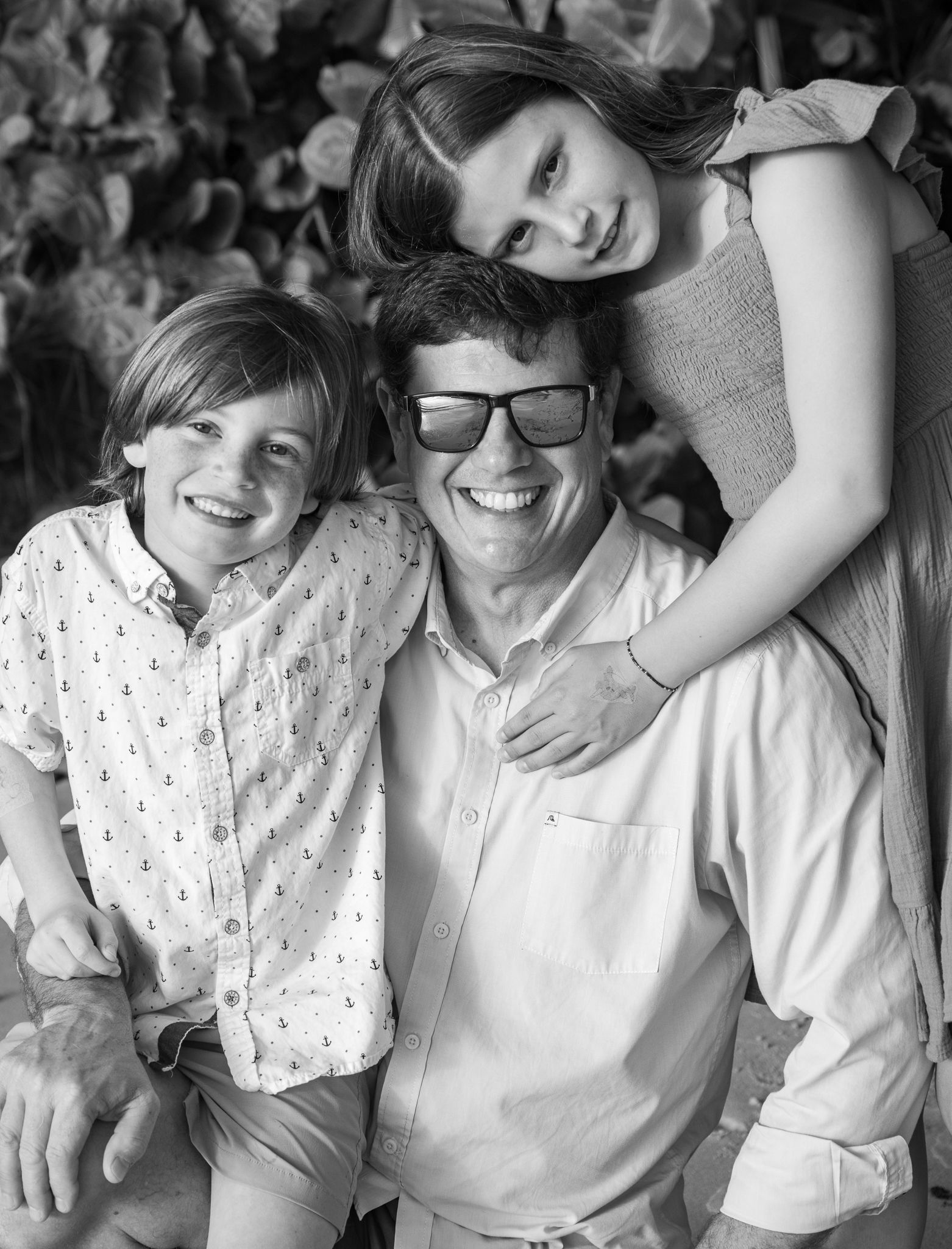 Kids hug dad.