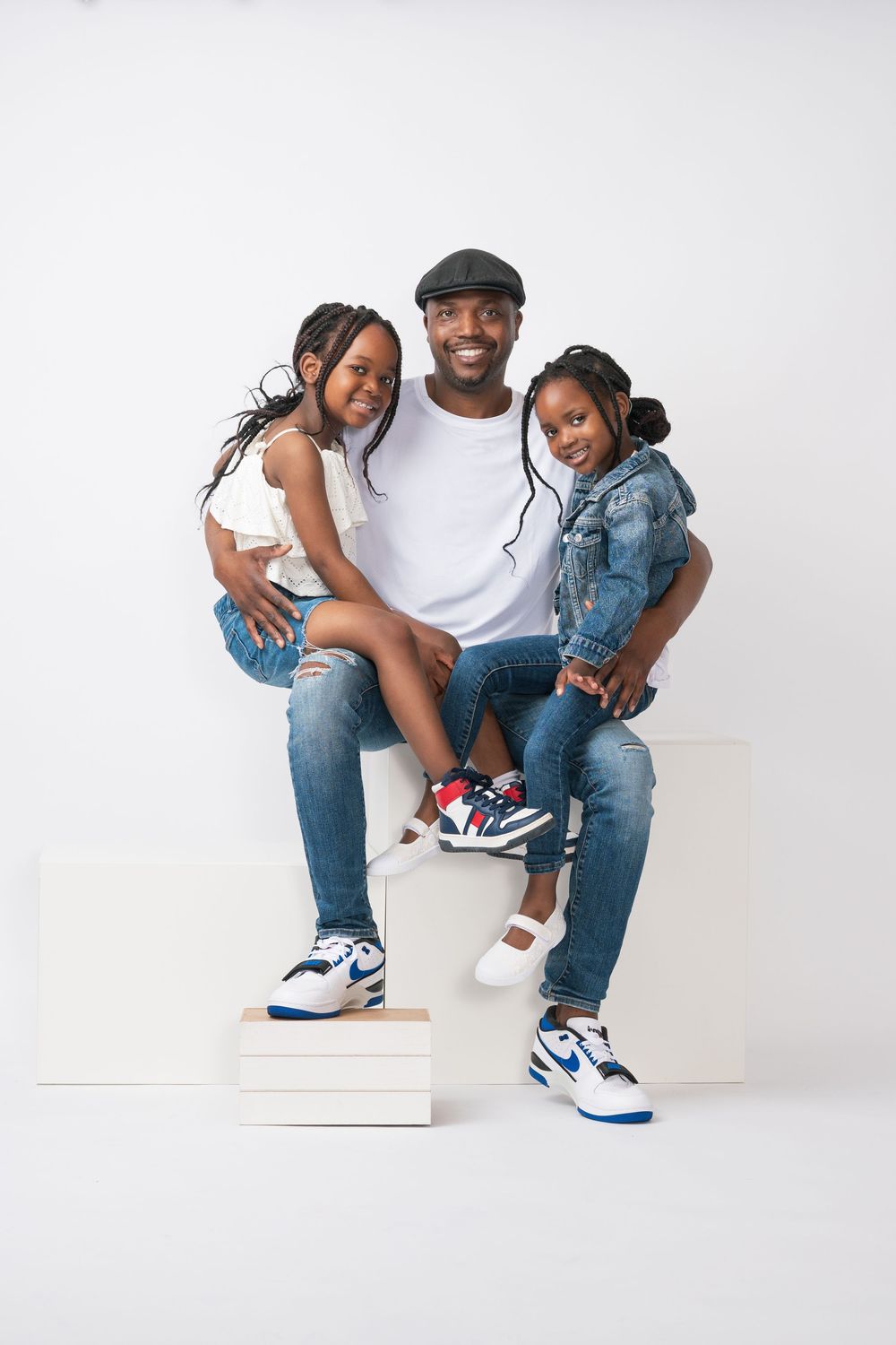 Family lifestyle portrait with relaxed and natural posing in the studio.