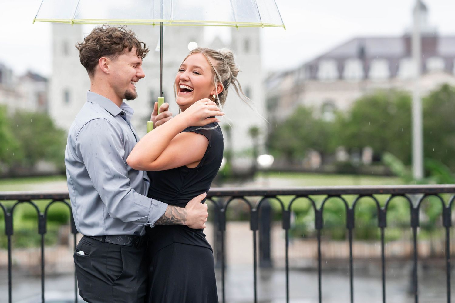 engaged couple under umbrella