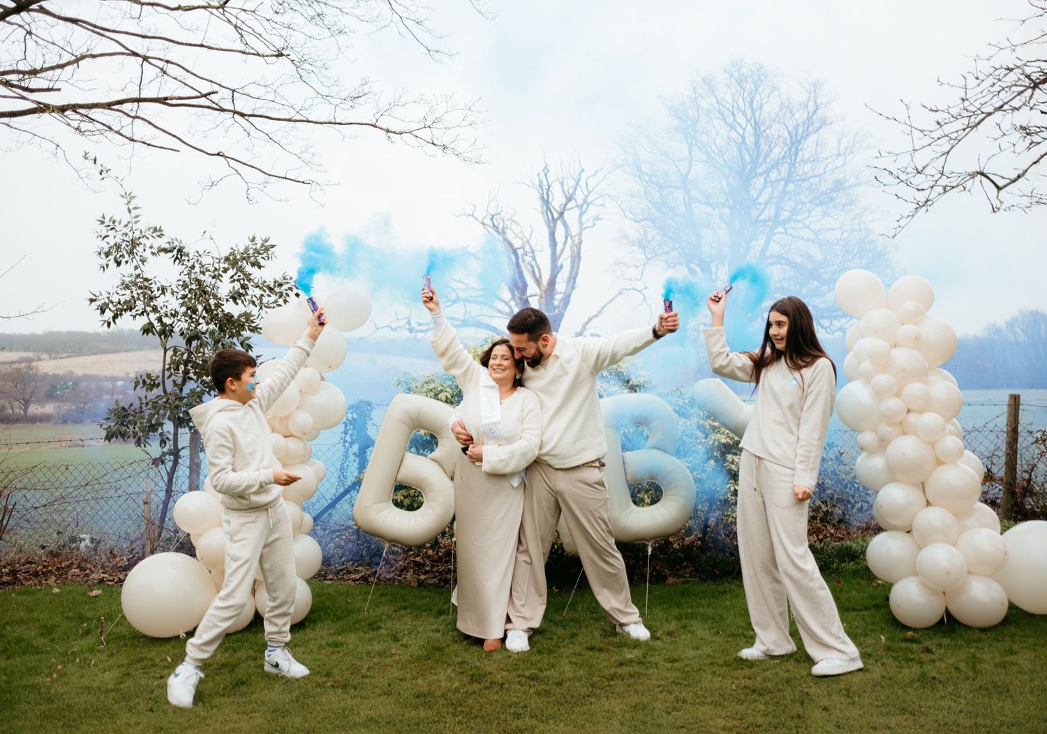 Outdoor baby shower gender reveal celebration blue and white balloons and festive decorations against a scenic backdrop in London