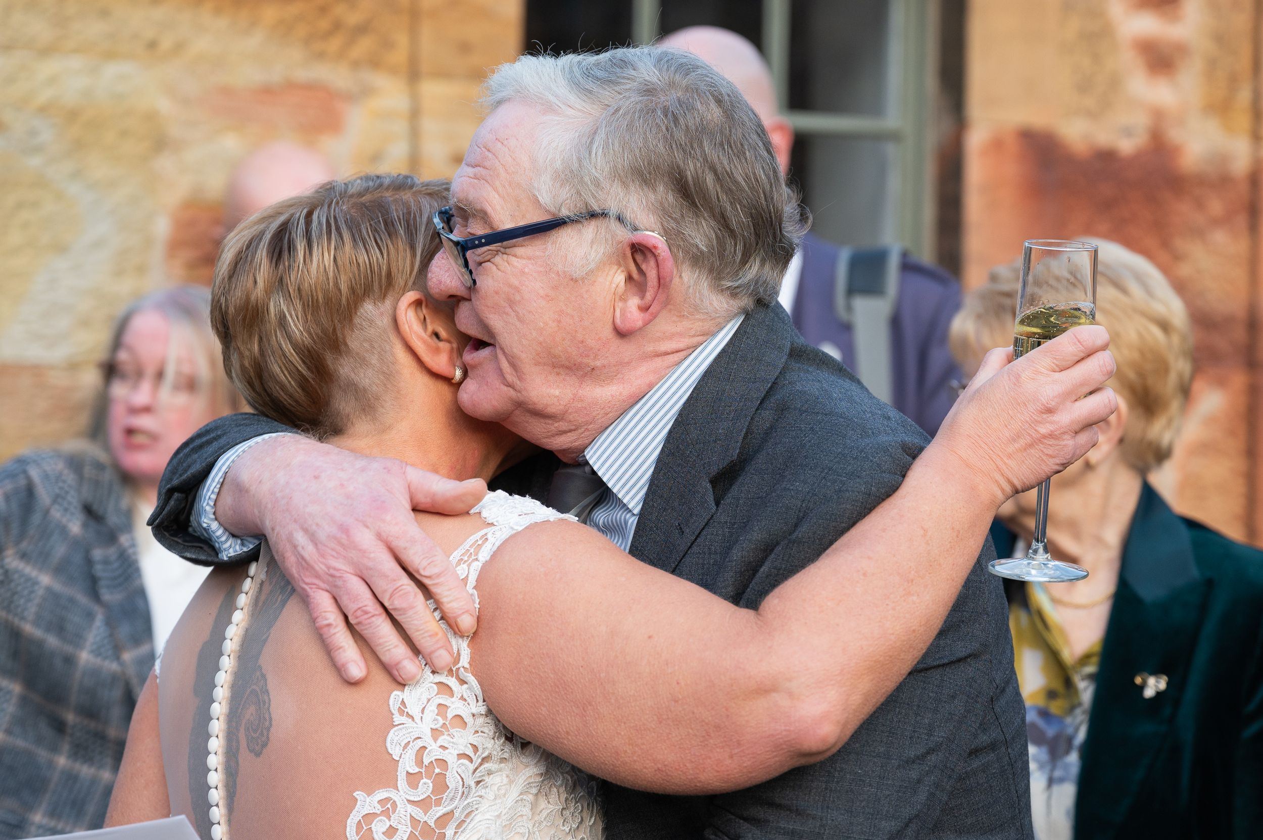 bride hugs man at dalkeith country park, Edinburgh