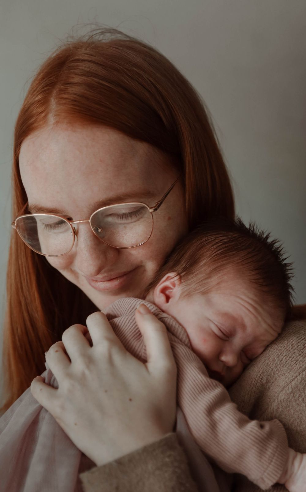 An intimate portrait of parent and baby sharing a tender moment.