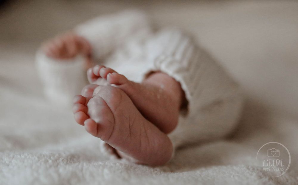 Series of close-up shots showing tiny baby feet against white fabric.