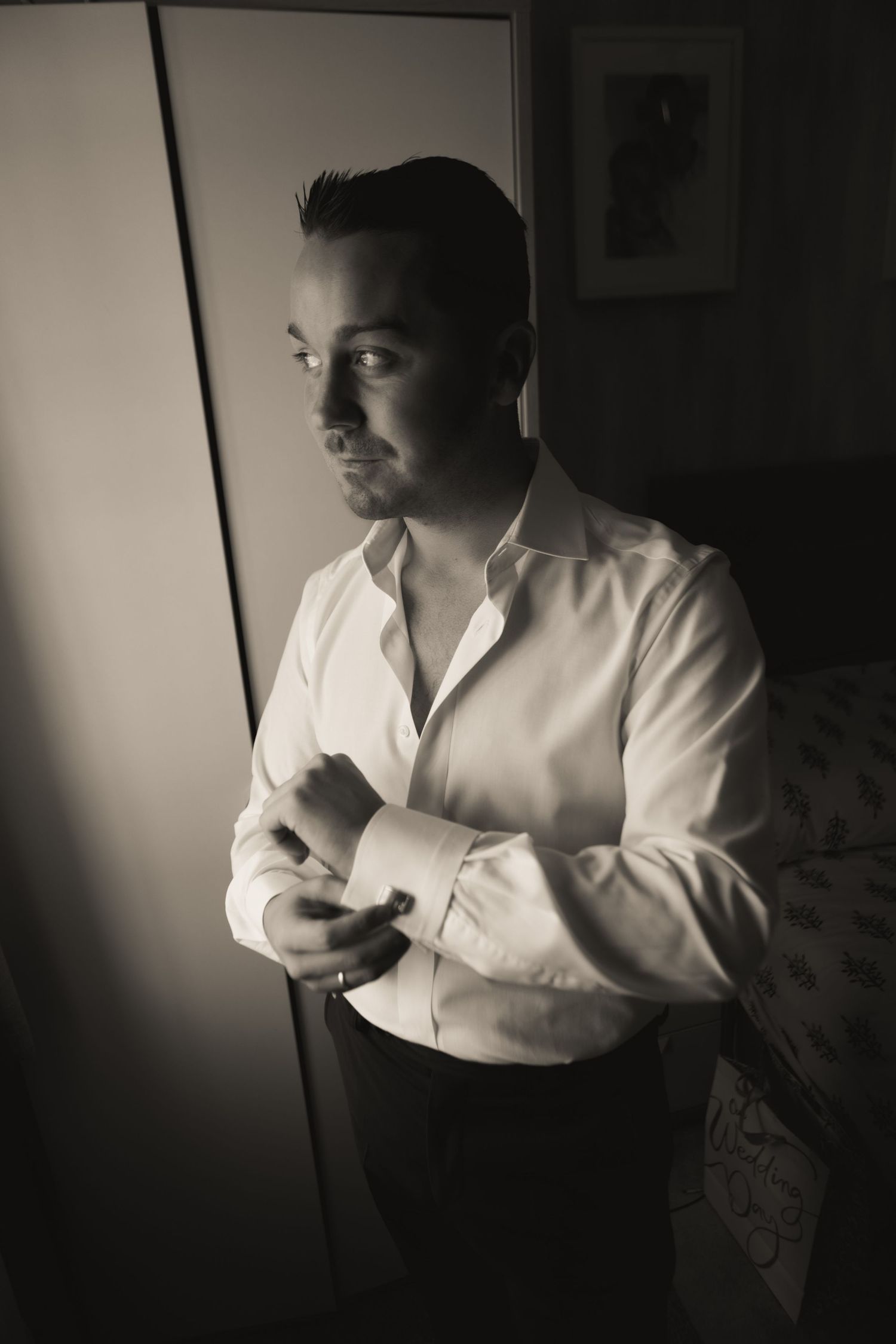 Dramatic black and white portrait in low key lighting with shadow play.