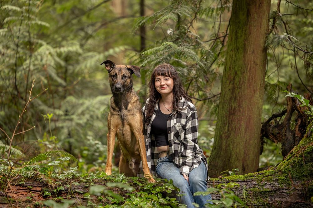 Dog and owner photographed outdoors in forest setting