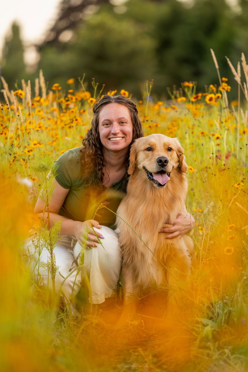Dog and owner photographed outdoors in flower field setting