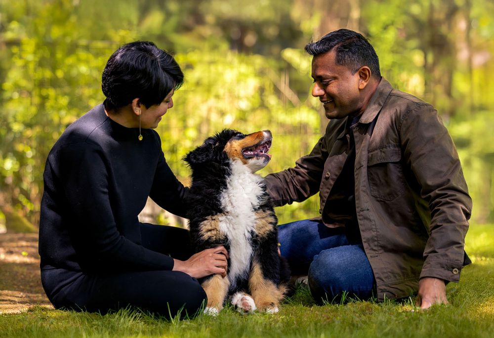 Dog and owner photographed outdoors in forest setting