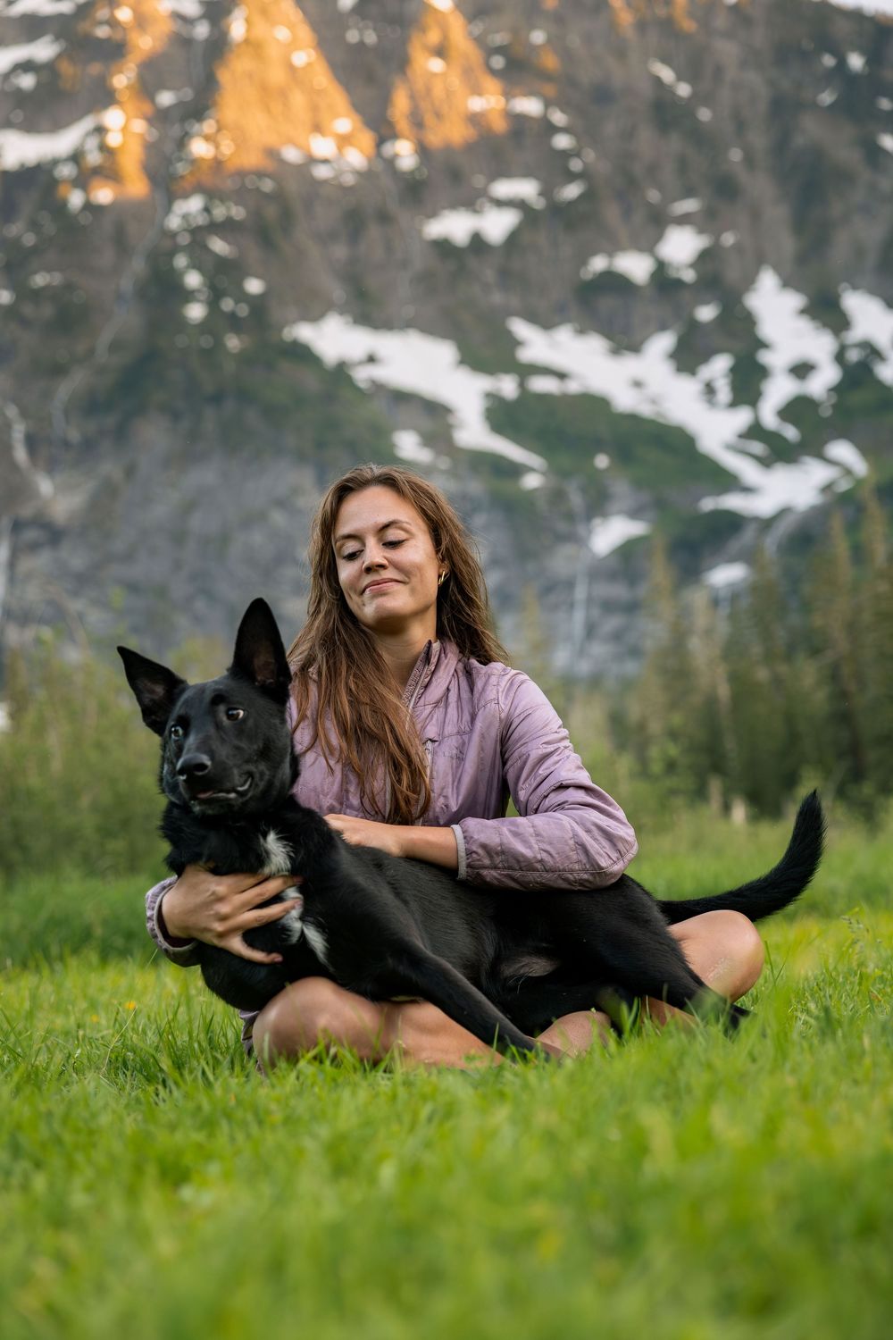 Dog and owner photographed outdoors in mountain setting
