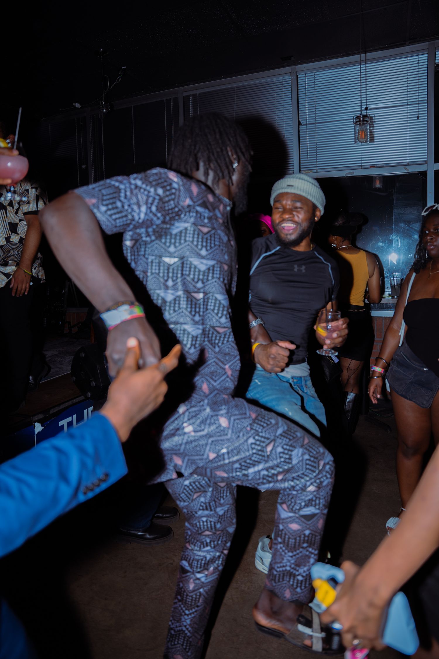 People dancing and socializing at nightclub party.