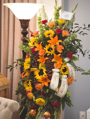 A full shot of a flower arrangement with sunflowers and lilies.
