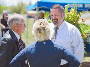 Three people talk after the graveside service