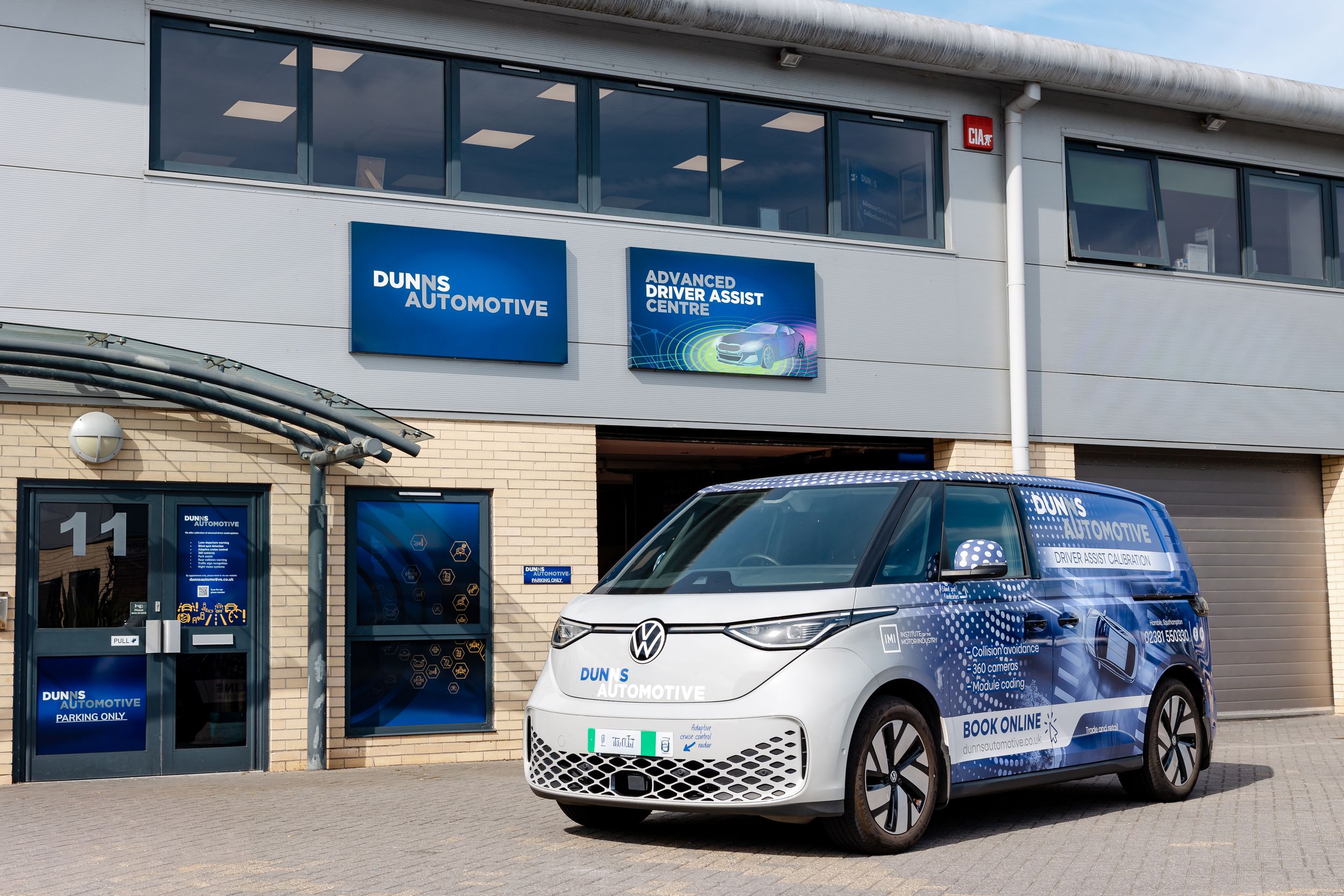 A Volkswagen ID.Buzz electric van parked outside Dunis Automotive Advanced Driver Assist centre in the UK.