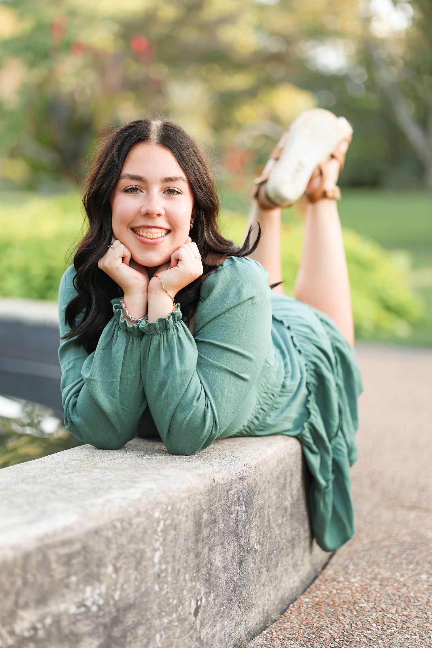 Central Illinois photographer captures a senior in front of a fountain during a senior session in Springfield, IL