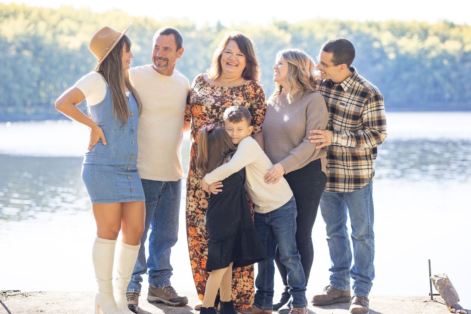 Central Illinois photographer captures a family together in front of a lake during a family photo session in Springfield, IL