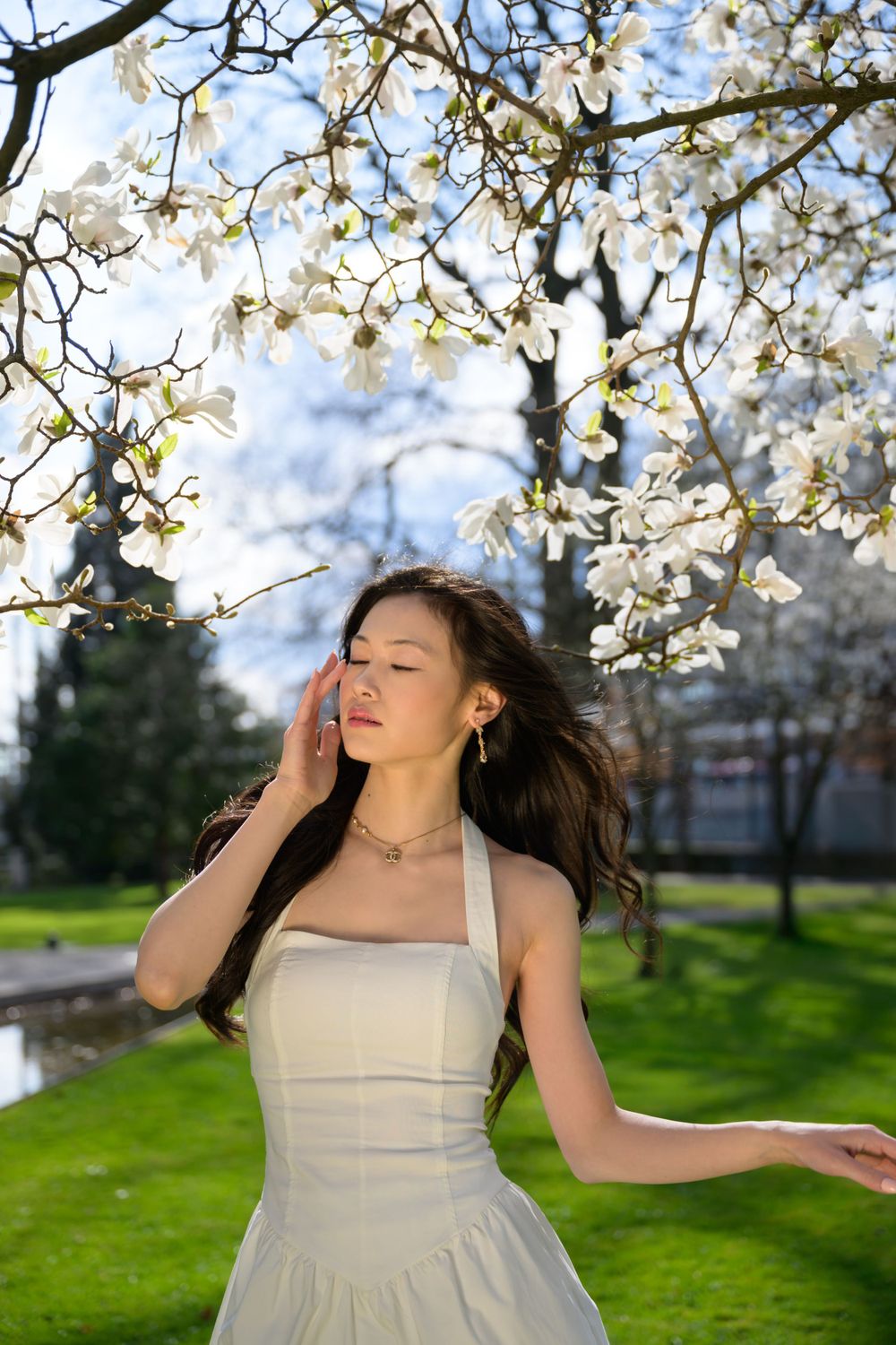 Zurich model in spring setting, wearing elegant white and gold jewelry. Soft natural light and subtle emotion.The best shoot ever