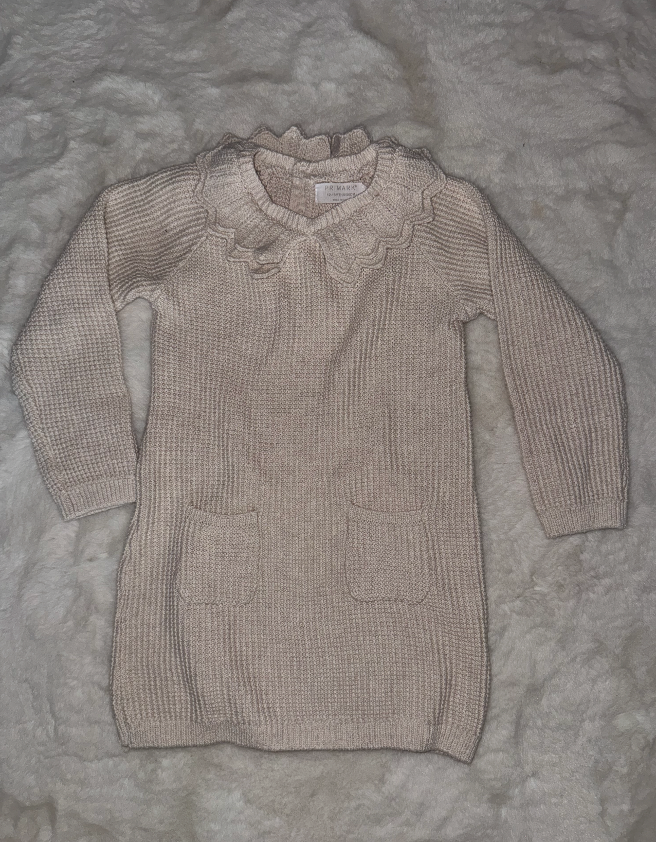 Beige knit baby sweater with ribbed texture and button details shown from multiple angles.