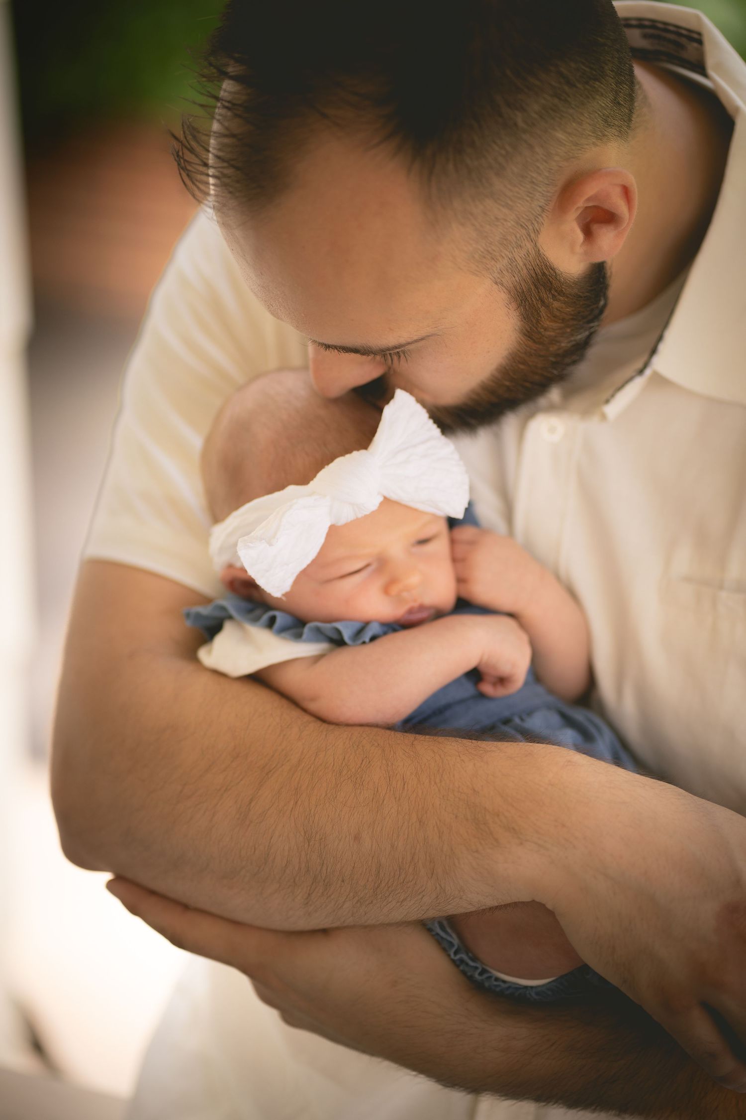 Series of tender images showing a newborn baby being cradled and held gently in caring arms.
