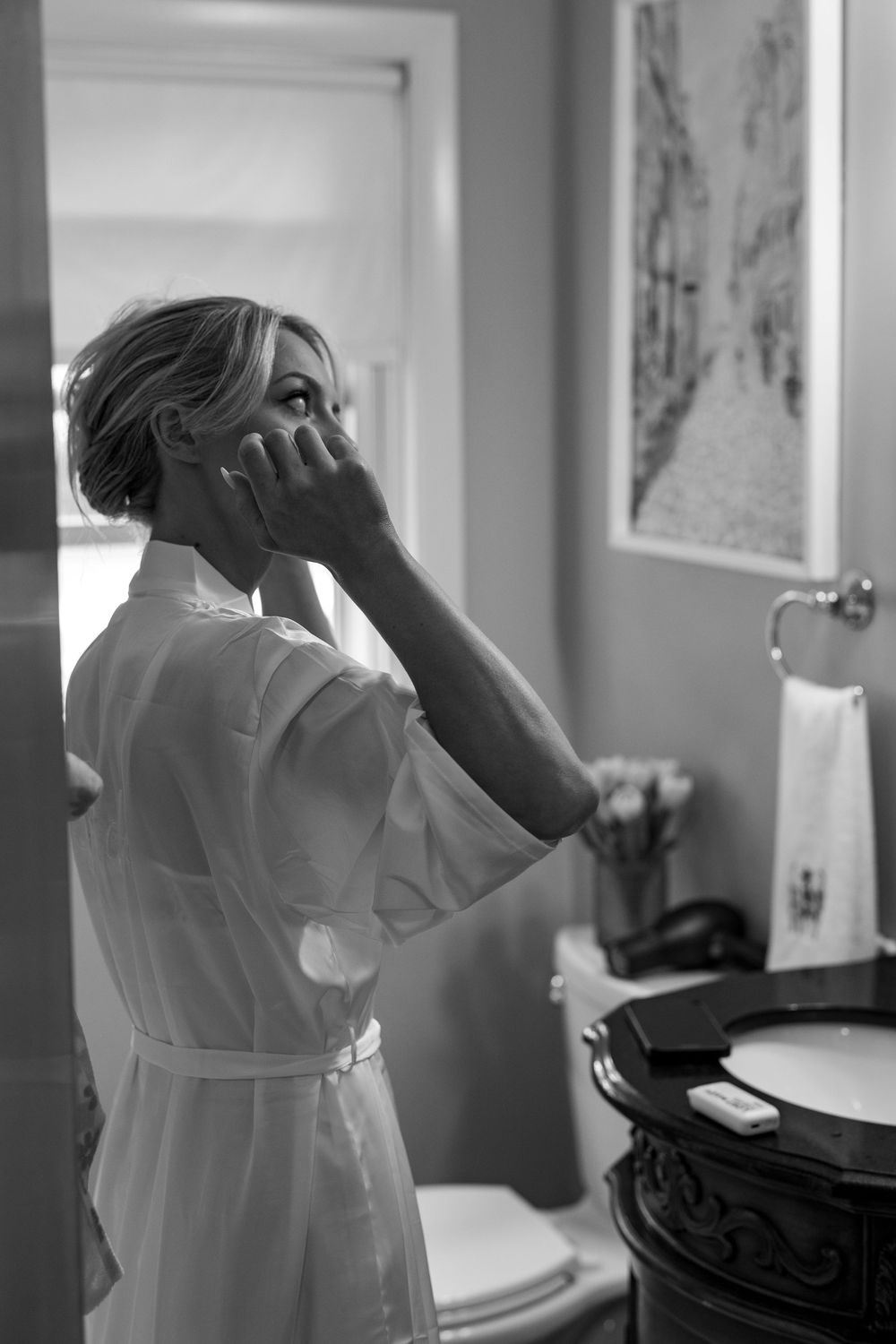 Black and white photos of wedding preparation in bathroom.