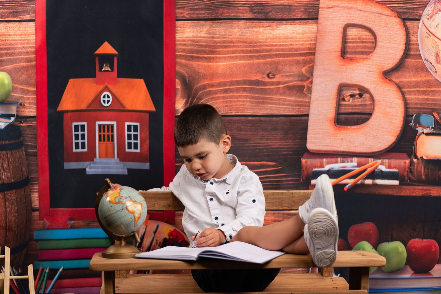Classroom themed photo setting with wooden panels and school decorations.
