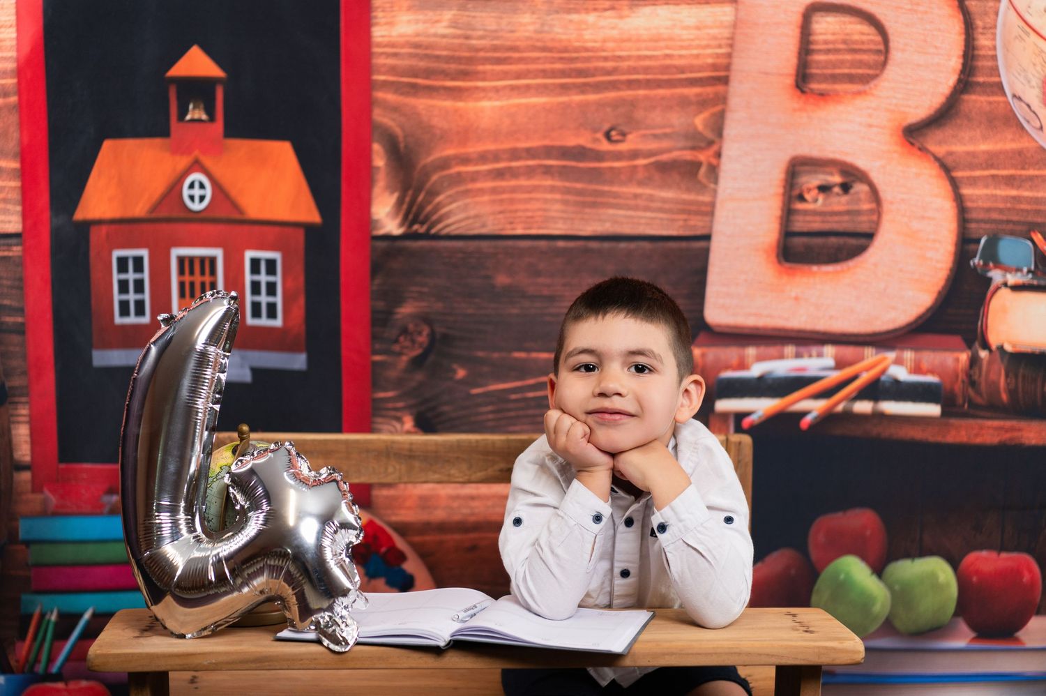 Educational setting with student desk and rustic decor featuring schoolhouse designs.