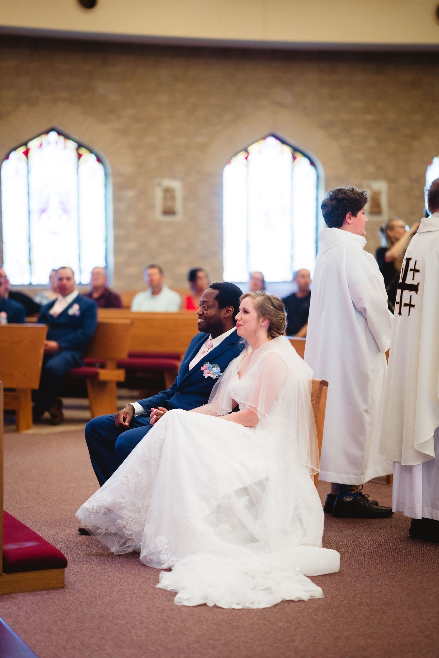 A sequence of four wedding ceremony photos showing a couple praying and kneeling at the church altar.
