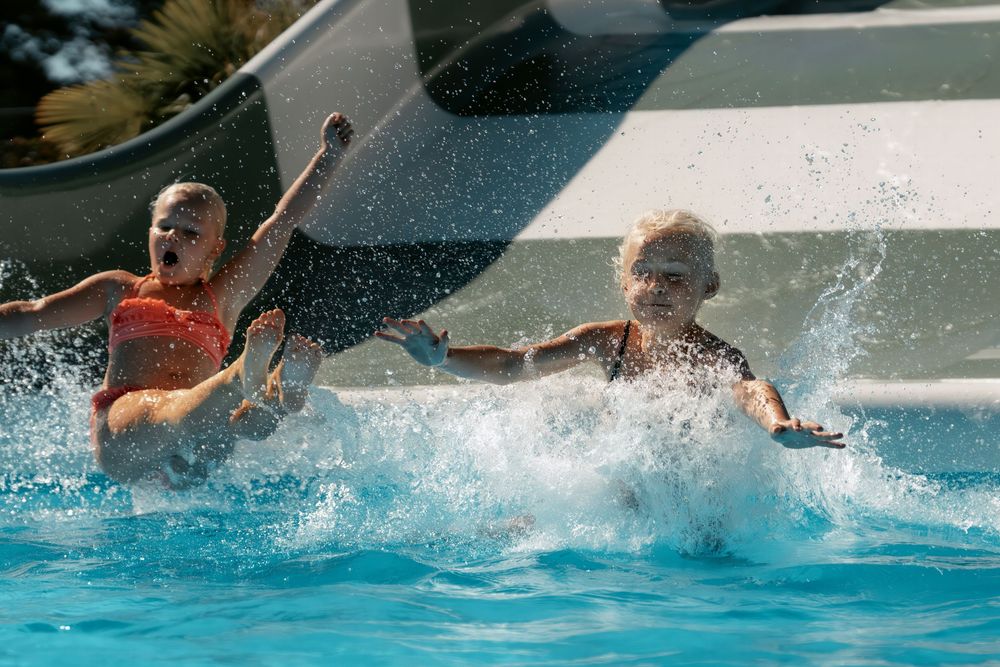People splashing and playing in a swimming pool with dynamic water movements.
