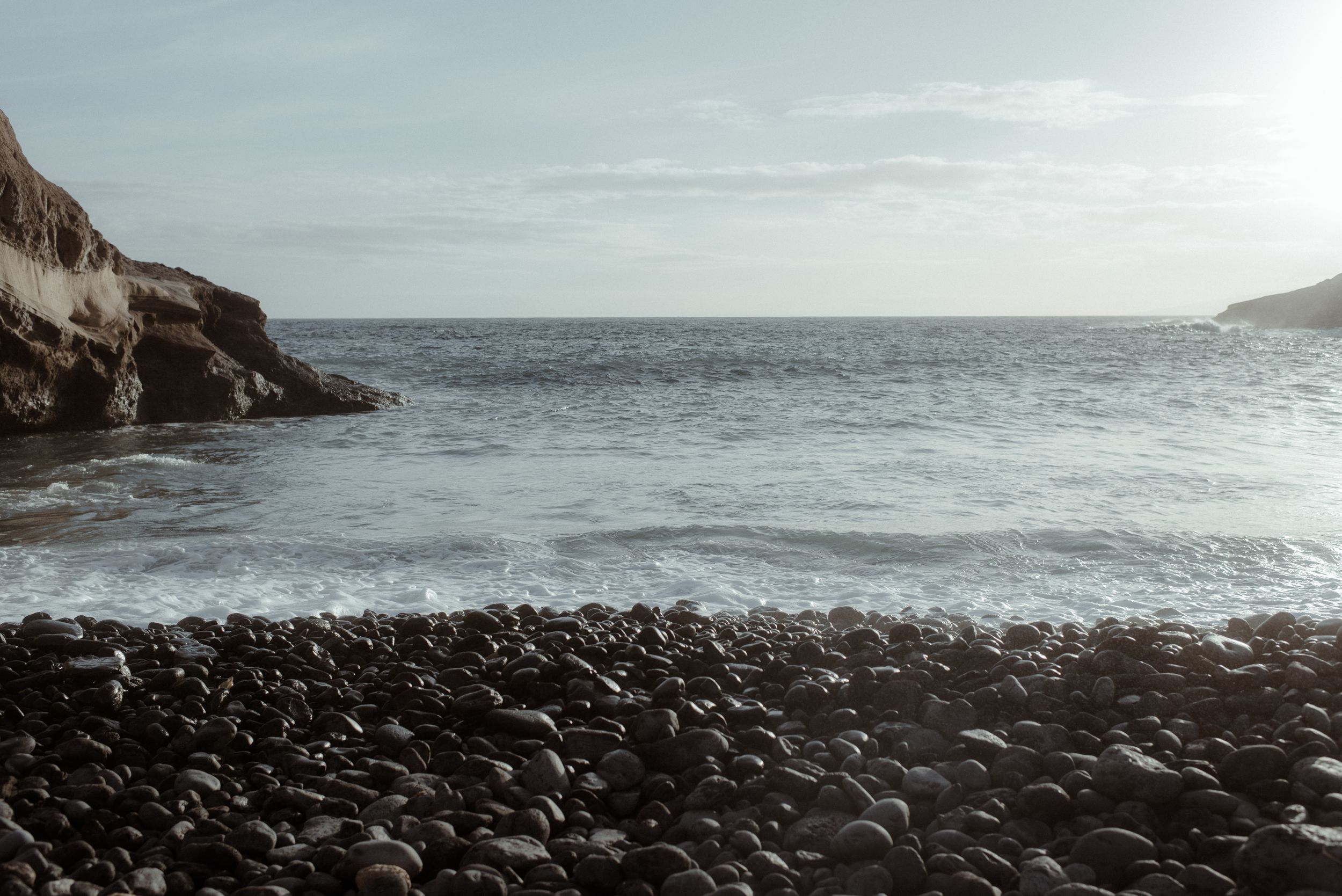 A series of panoramic coastal landscapes showing rocky cliffs and ocean waves under cloudy skies in La Caleta de Adeje, Tenerife.