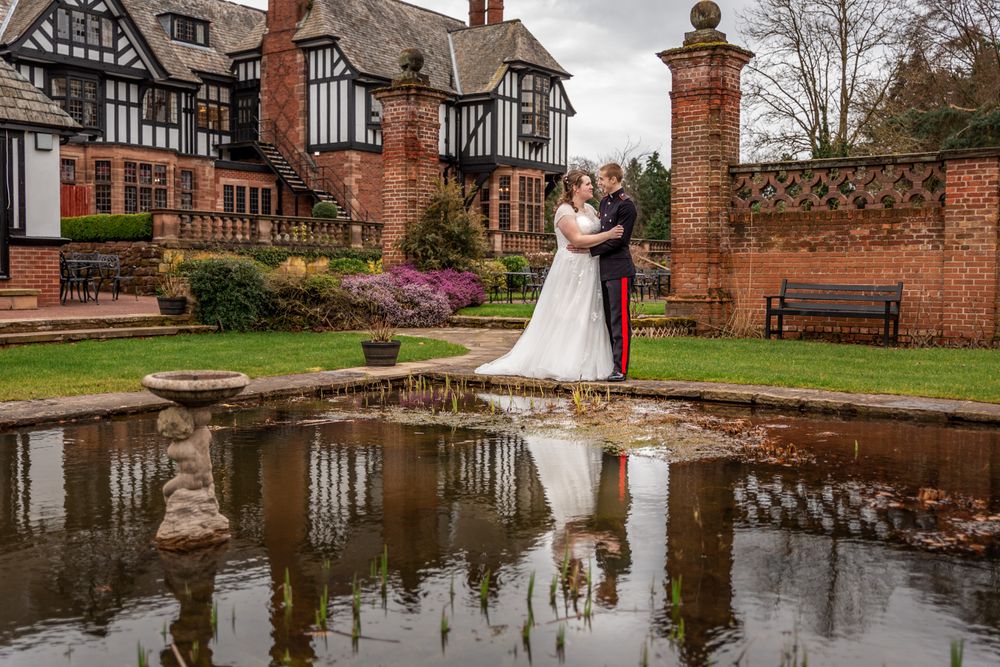 Wedding Portrait of a couple reflected in a formal pool at Inglewood Manor, Cheshire. Cheshire Wedding Photographer