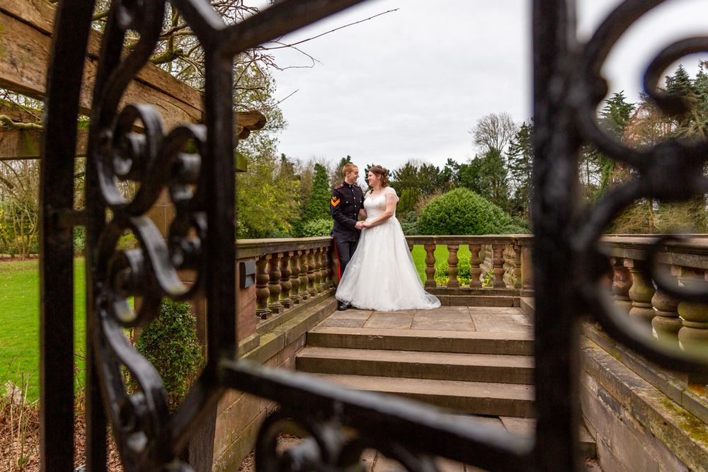 Candid wedding portrait of a couple on the terrace at Inglewood Manor, Cheshire. Light and airy wedding photography.