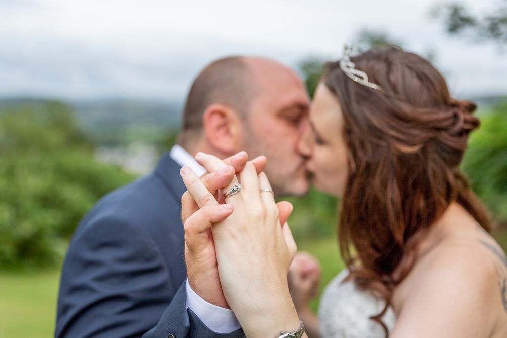Wedding portrait of a couple kissing out on the course at Bala Golf Club. Light, airy wedding photography. Gwynedd Wedding Photographer