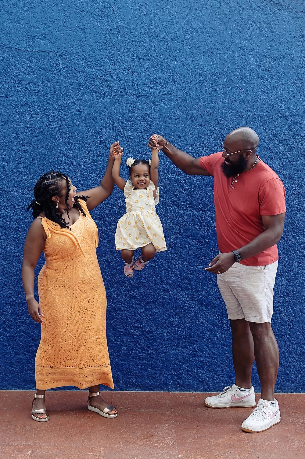 A sequence of photos showing playful poses against a bright blue wall.