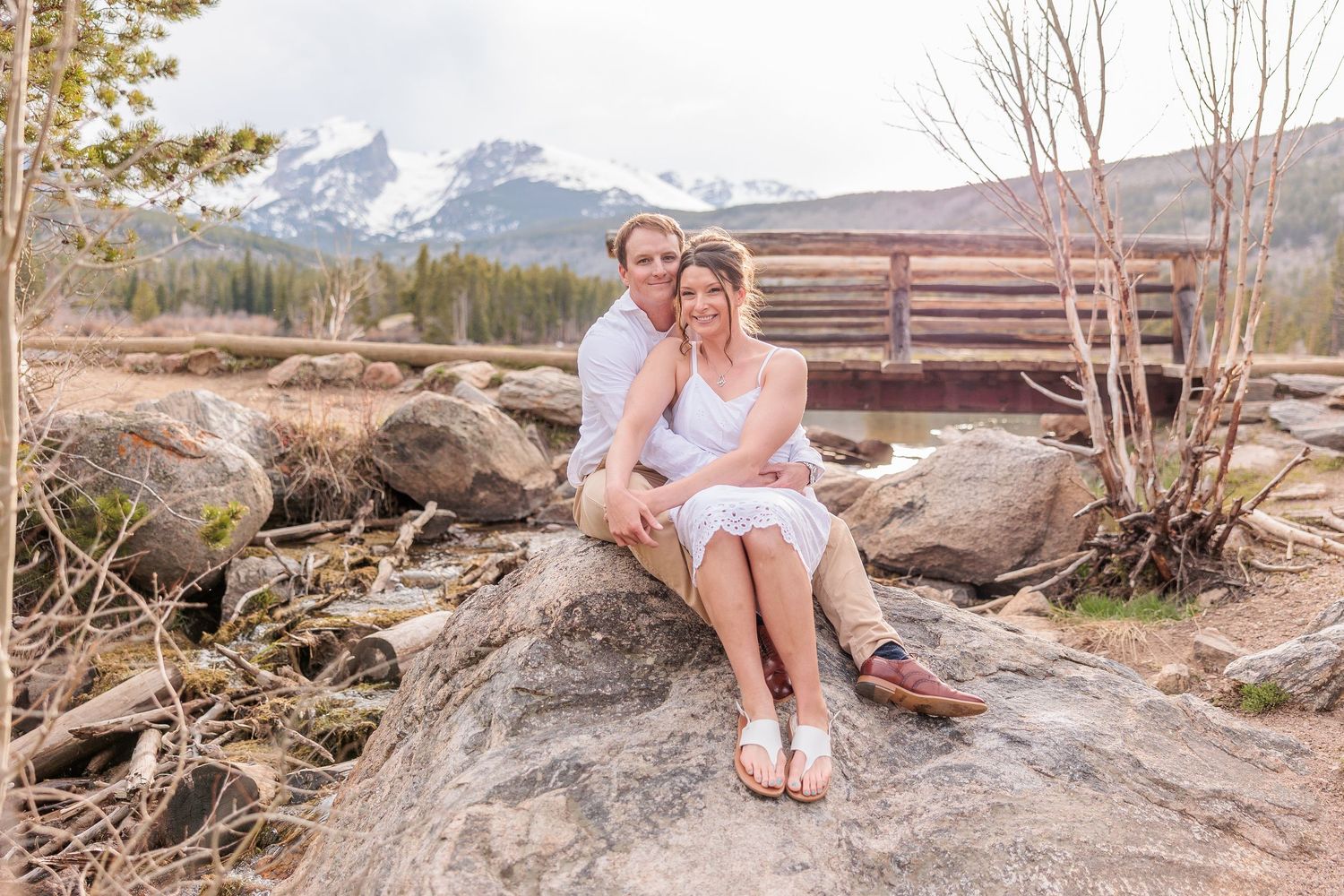 elopement couple by calm Sprague Lake, sunrise reflection of mountains in water, accessible and romantic RMNP location