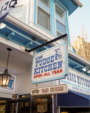 Vintage blue and white Fudge Kitchen storefront sign advertising year-round service.