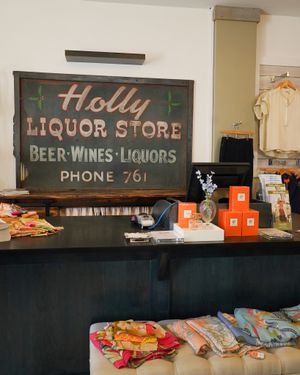 Retro Holly Liquor Store sign with vintage product displays.