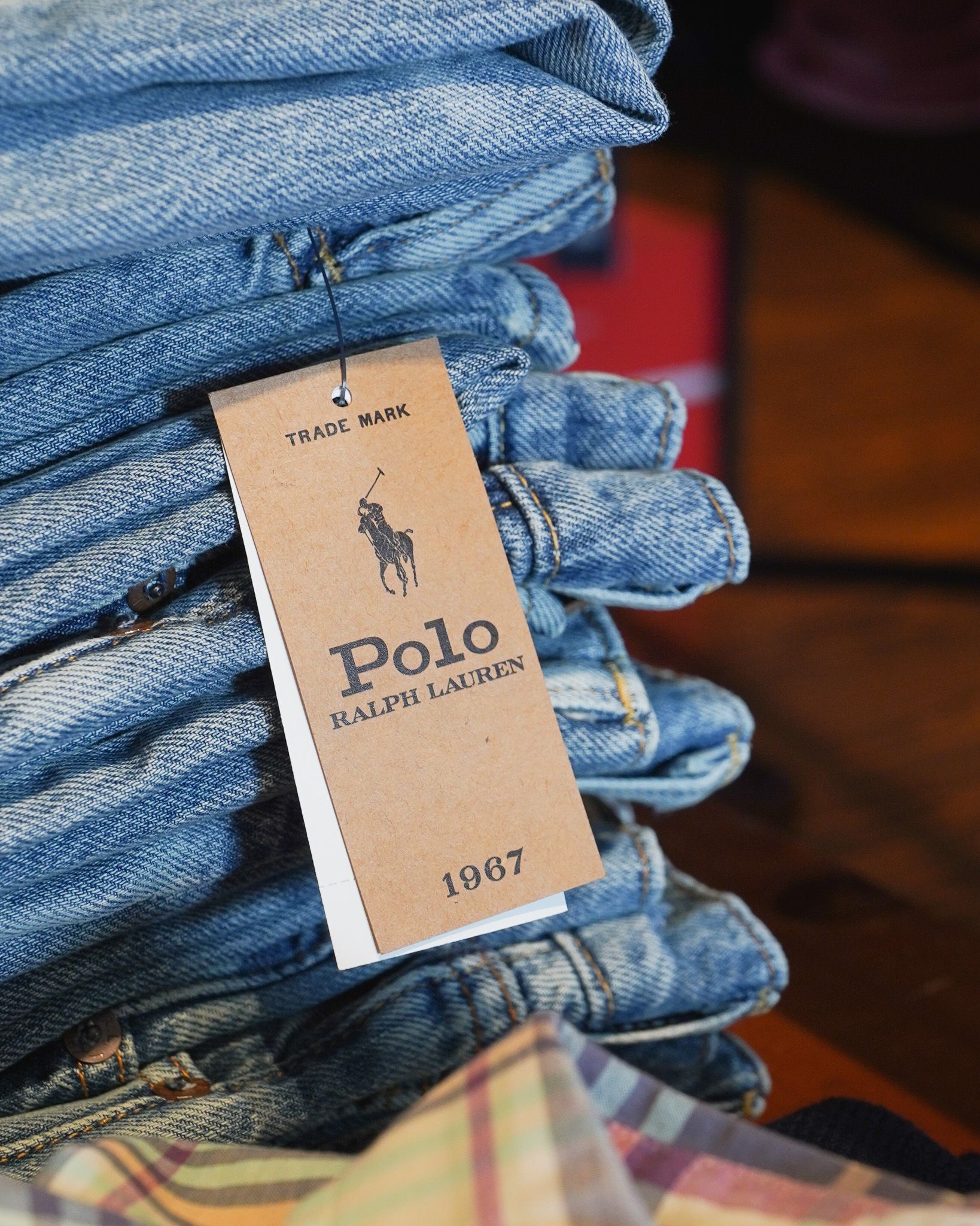 Stack of folded Polo Ralph Lauren jeans with brand tag.