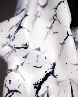Close-up of white fabric with abstract navy blue marble pattern design.
