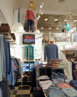 Retail clothing store interior with mannequins and clothing displays.