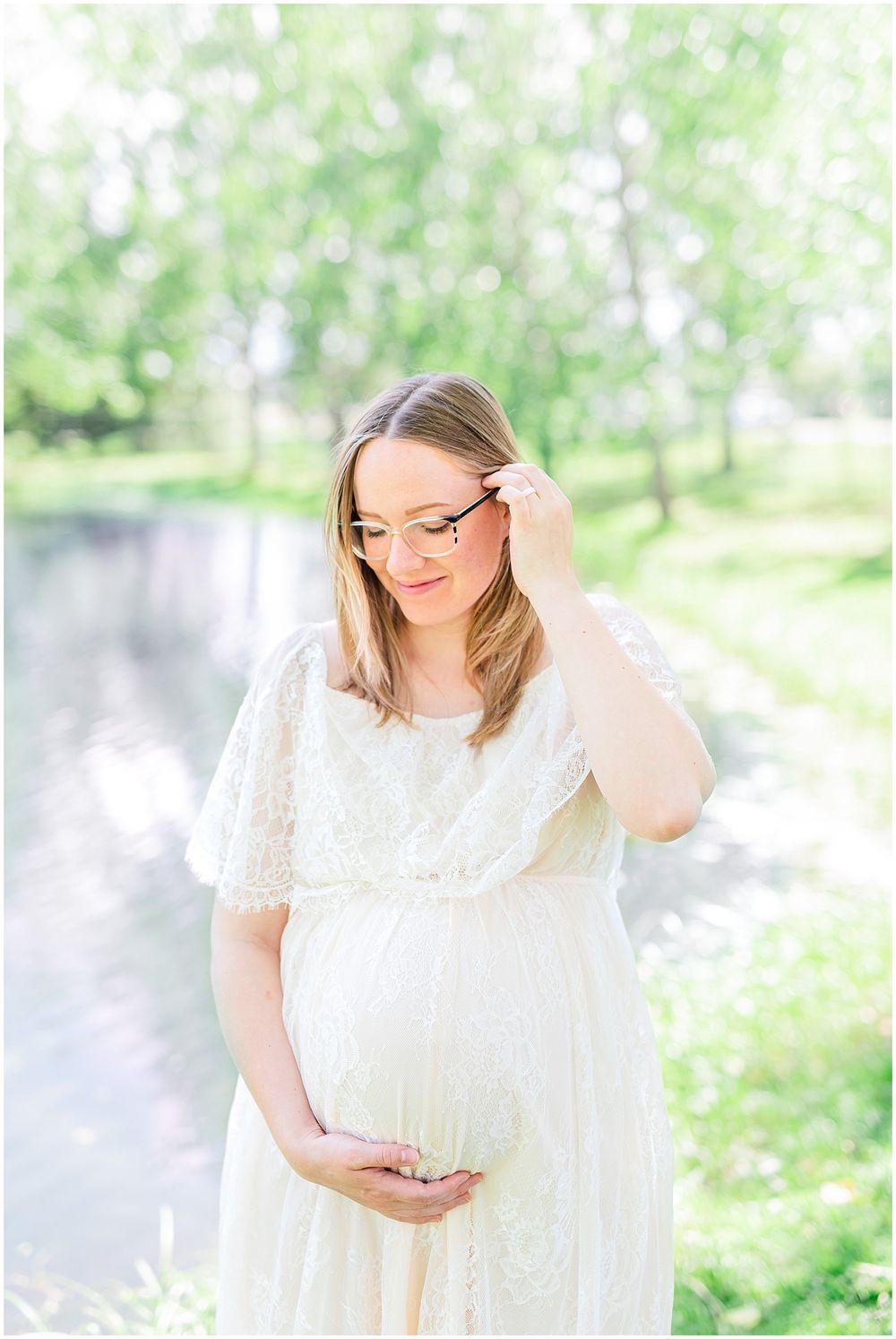 A maternity photo captured in a dreamy garden setting with soft natural lighting. Light & airy photography style.
