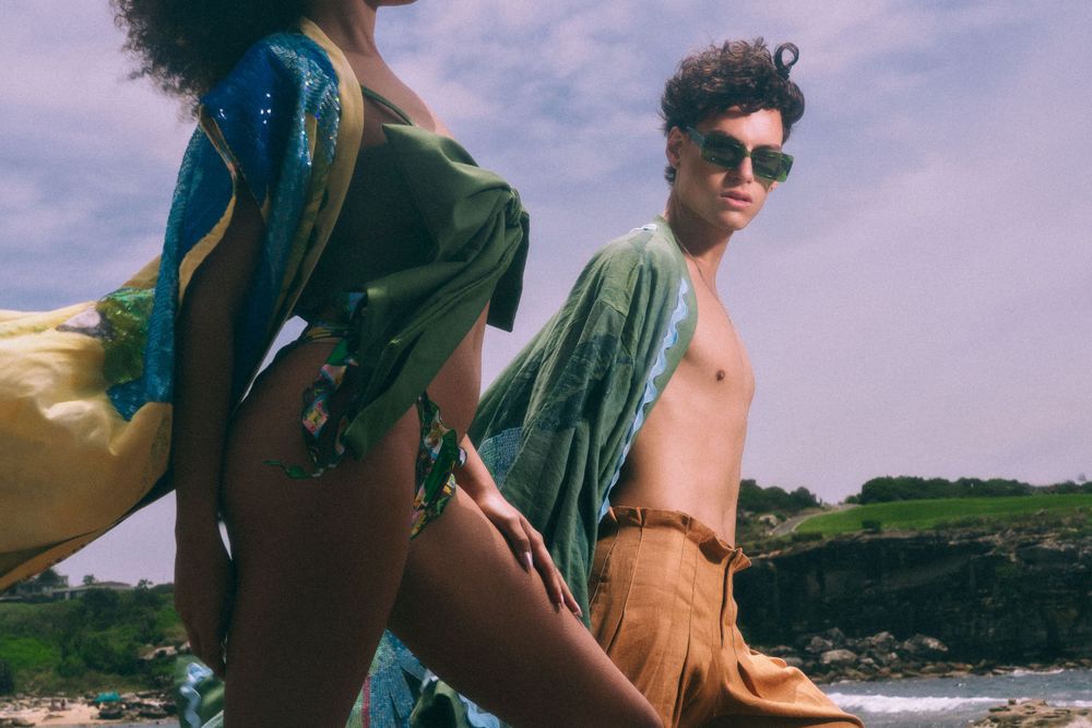 Beachside fashion shoot featuring models in casual summer clothing.