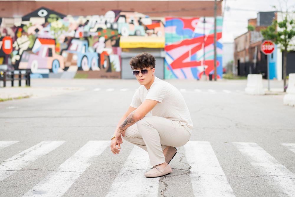 Street fashion photography on urban crosswalk in all-white outfit.
