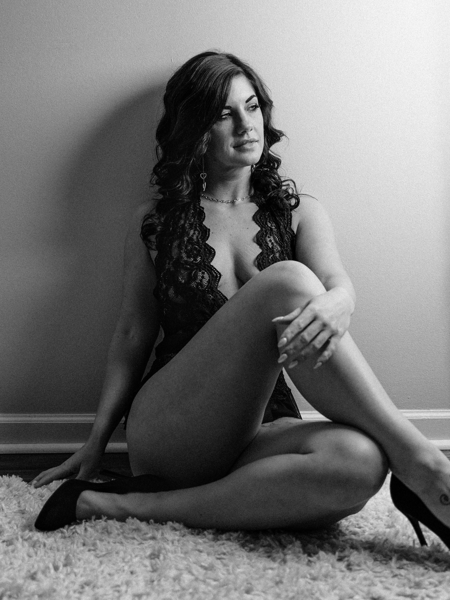 Boudoir portrait of a Knoxville woman leaning on a wall taken by dandridge TN boudoir photographer for her birthday photo session