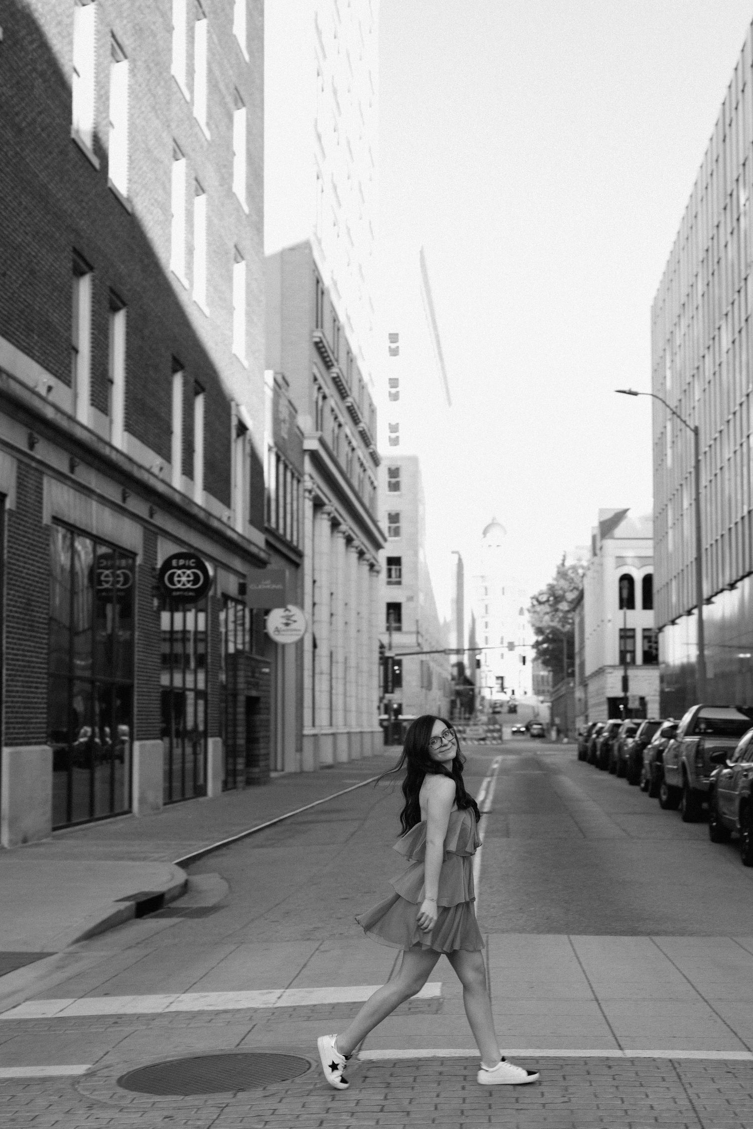A series of black and white photos showing someone kicking a soccer ball on an urban sidewalk. Chattanooga Senior Photographer