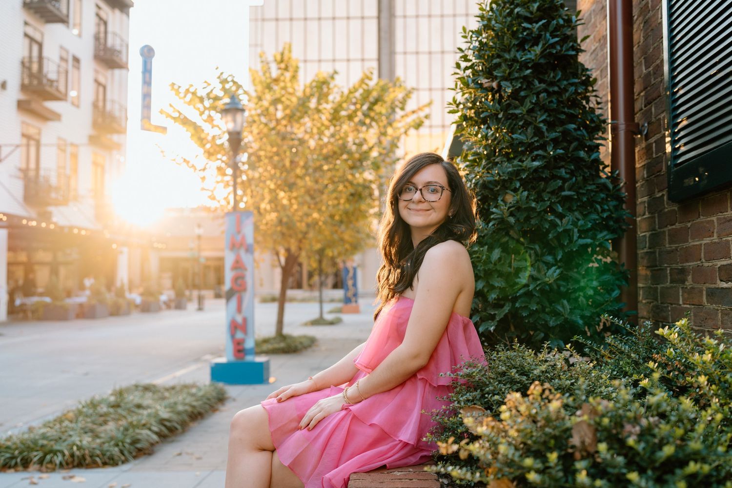 Sunset photoshoot in an urban setting with autumn trees and modern buildings in the background. Chattanooga Senior Photographer
