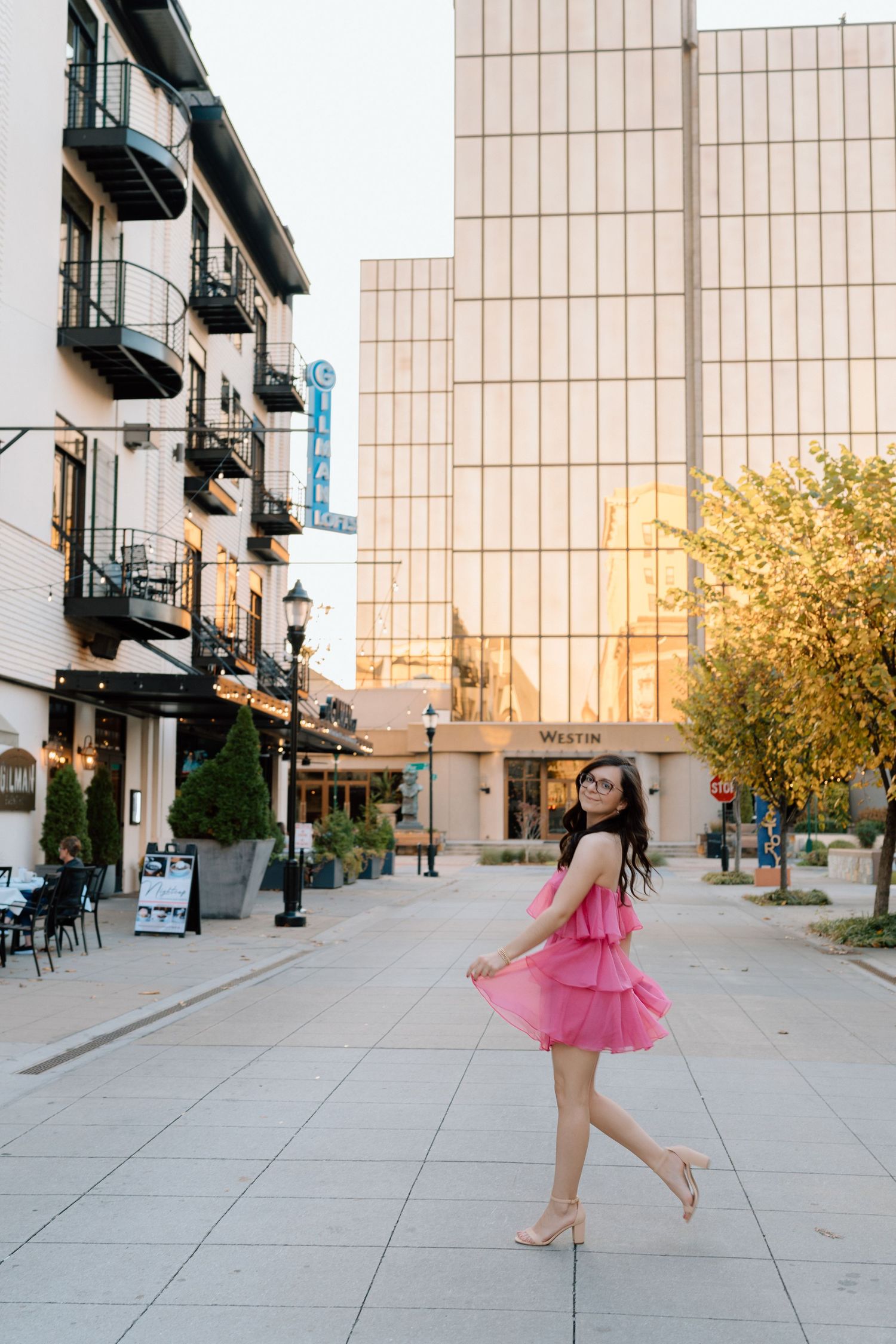 Graceful dance movements captured in a series of photos on a city sidewalk at sunset. Chattanooga Senior Photographer