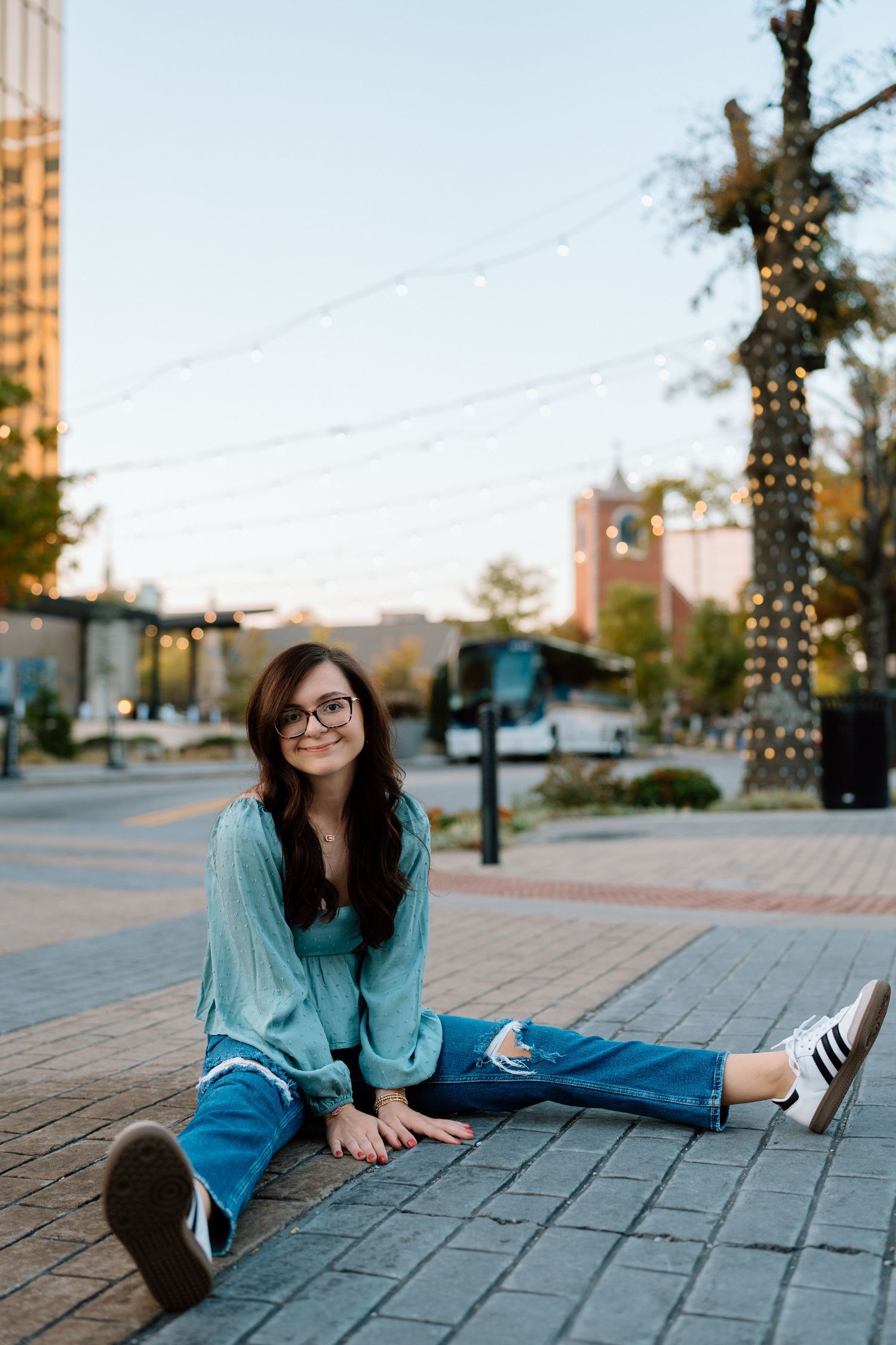 Casual poses on brick pavement wearing a denim jacket and sneakers. Chattanooga Senior Photographer