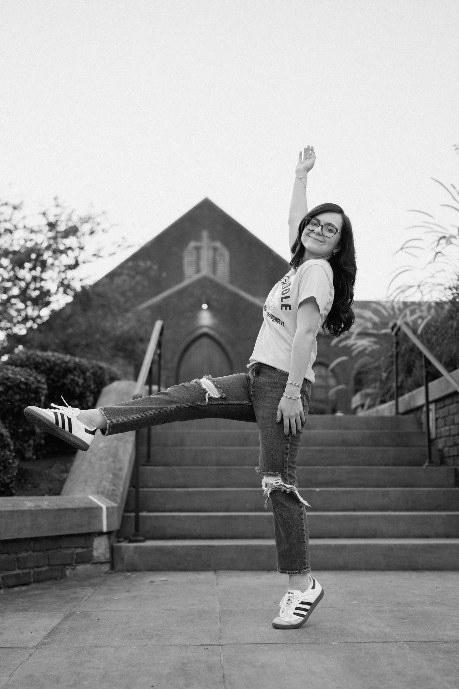 Black and white sequence showing joyful jumping poses on church steps. Chattanooga Senior Photographer