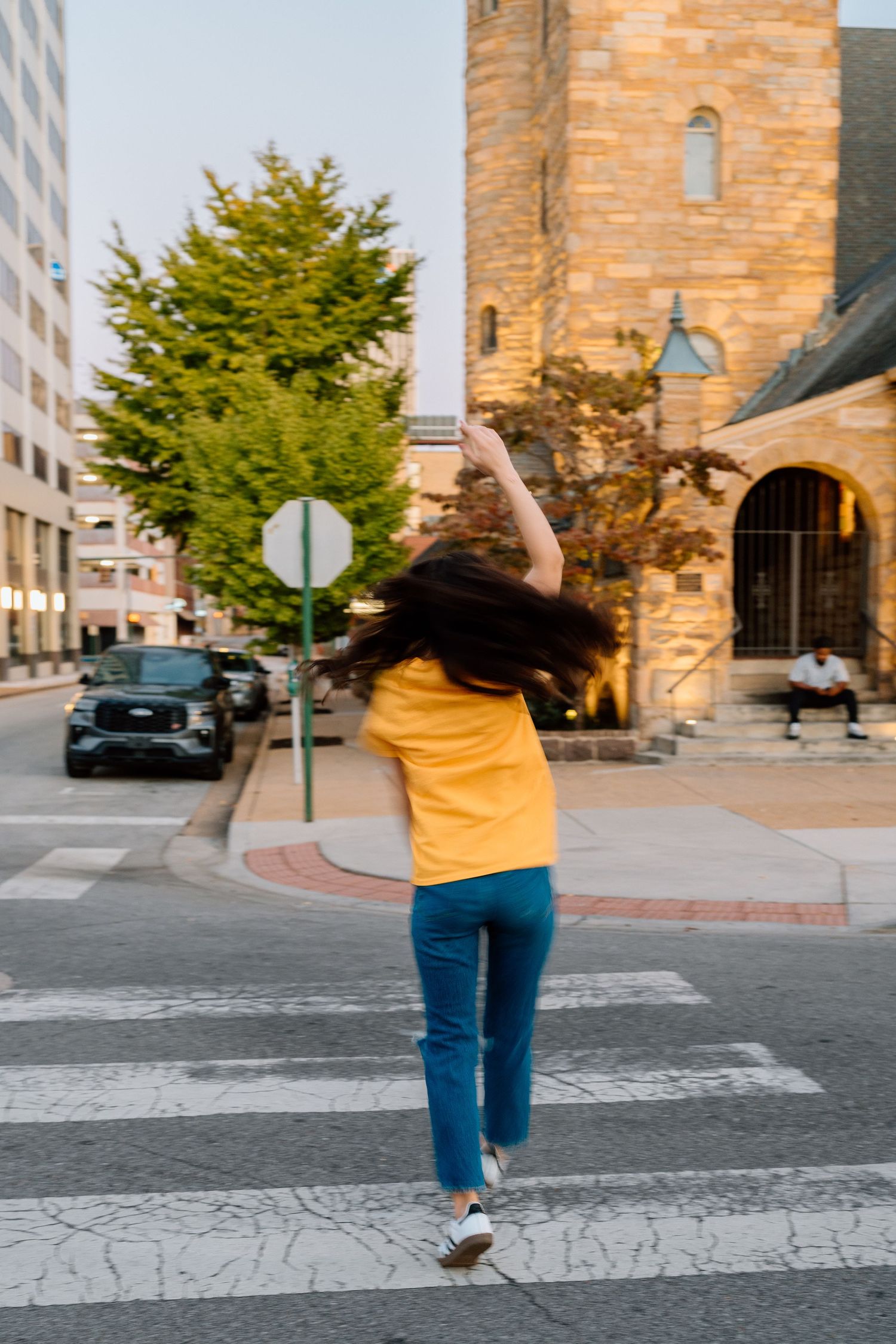 Series of photos showing someone dancing joyfully on a city street at sunset. Chattanooga Senior Photographer