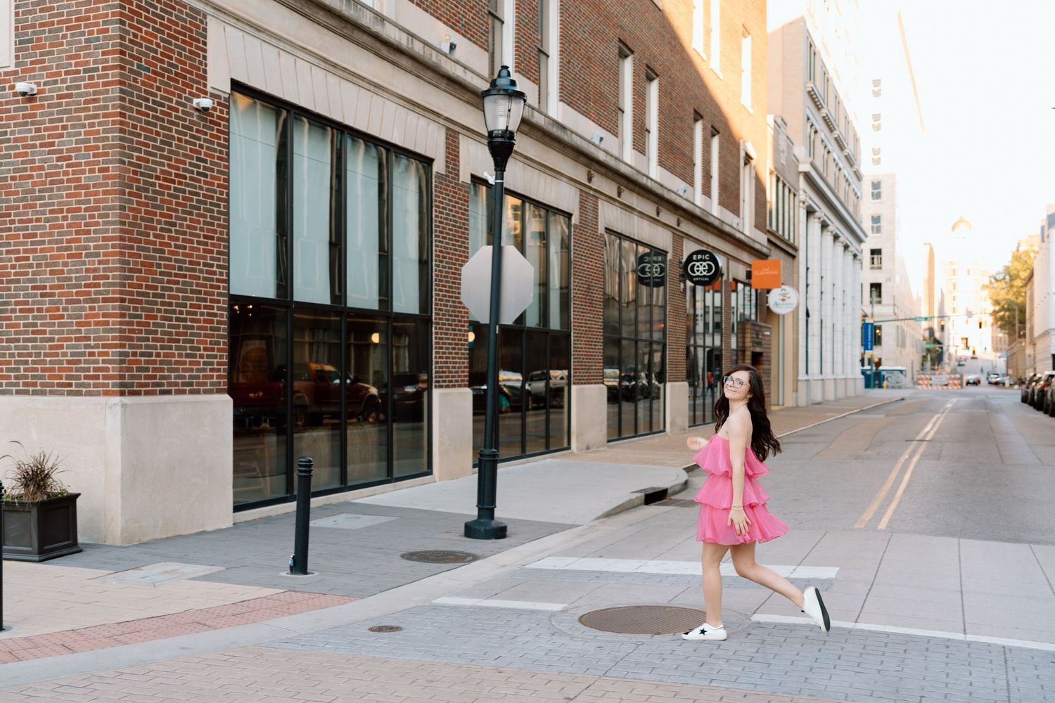 Urban street scene with brick buildings and lamp posts at sunset.  Chattanooga Senior Photographer