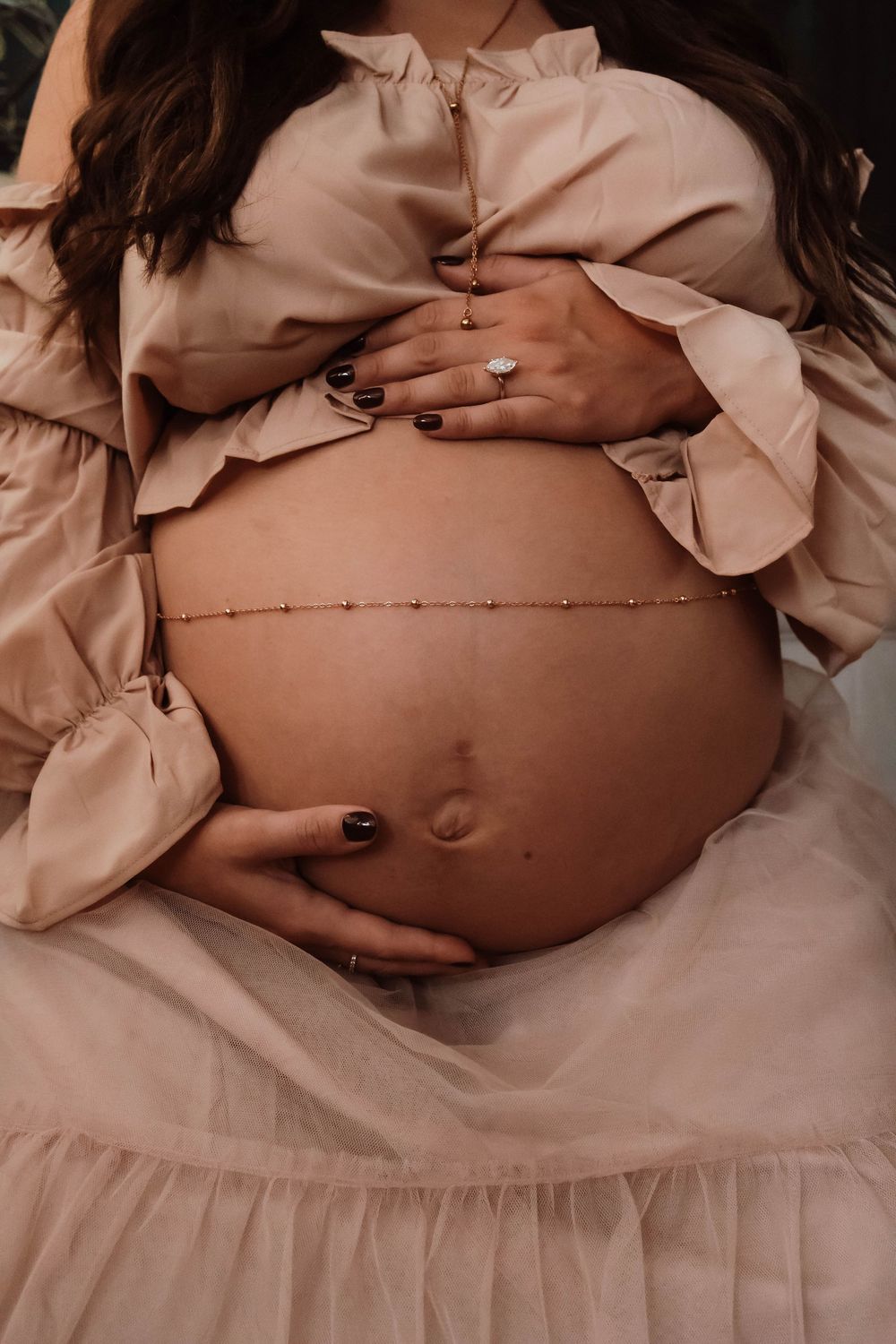 subtle maternity detail captured in a private studio setting